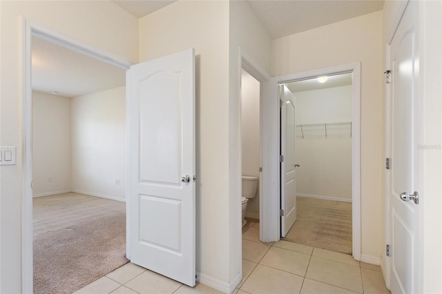 corridor featuring light colored carpet