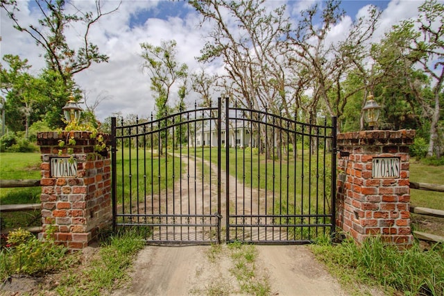 view of gate featuring a lawn