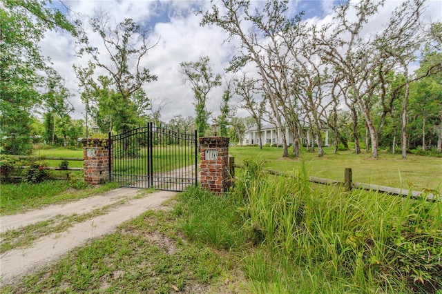 view of gate featuring a yard