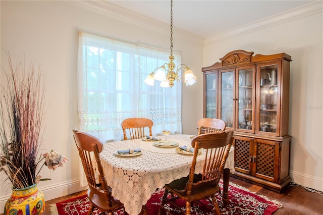 dining area featuring ornamental molding and an inviting chandelier