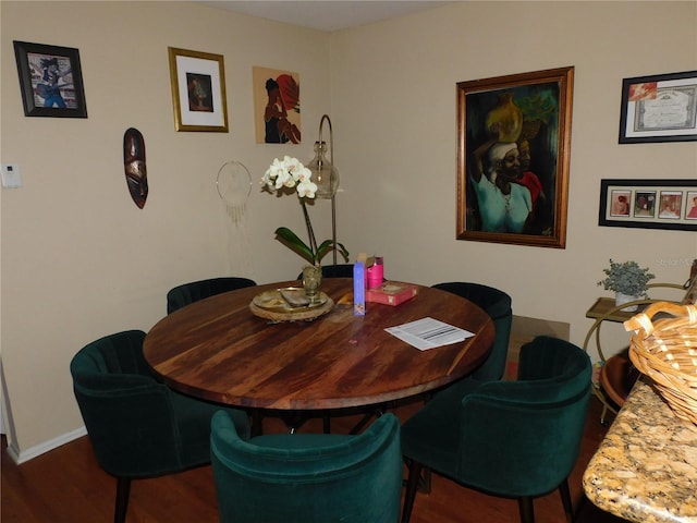 dining space with dark hardwood / wood-style flooring