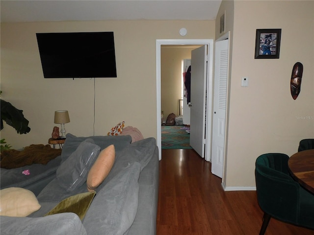 living room with dark hardwood / wood-style flooring