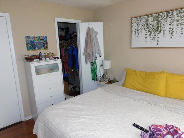 bedroom with a closet and dark hardwood / wood-style flooring