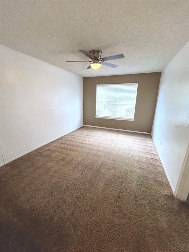 empty room featuring carpet flooring, ceiling fan, and a textured ceiling