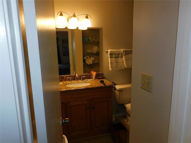 bathroom with toilet, a baseboard heating unit, and vanity