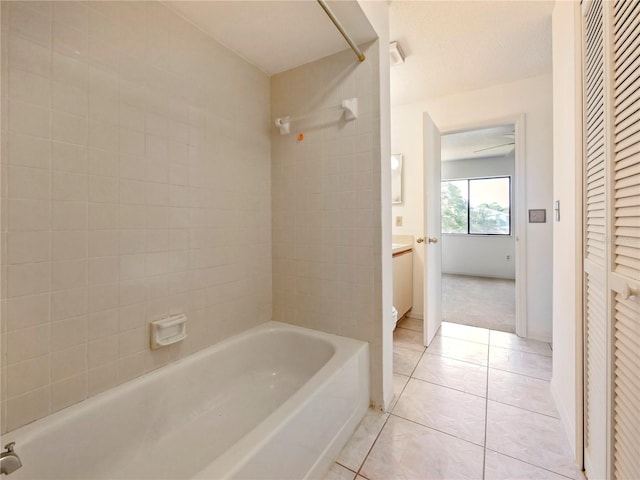 bathroom with tile patterned flooring and tiled shower / bath