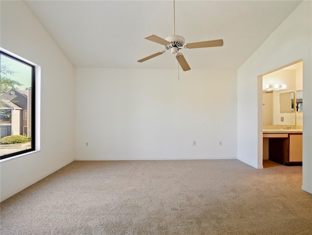 carpeted spare room with ceiling fan and lofted ceiling