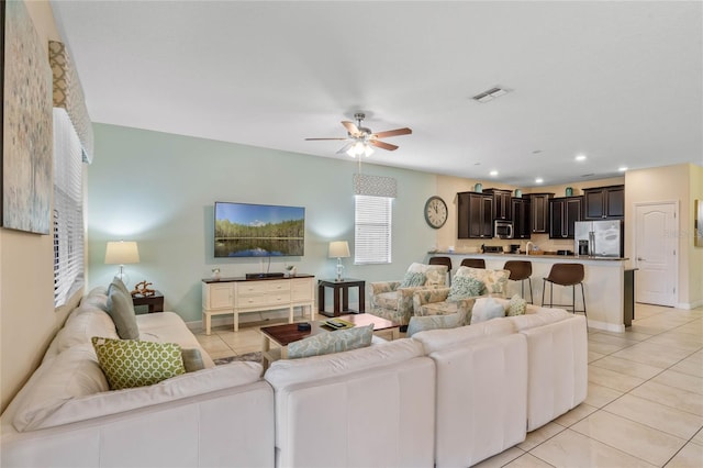 tiled living room with ceiling fan