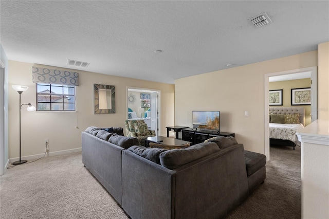 carpeted living room with a textured ceiling