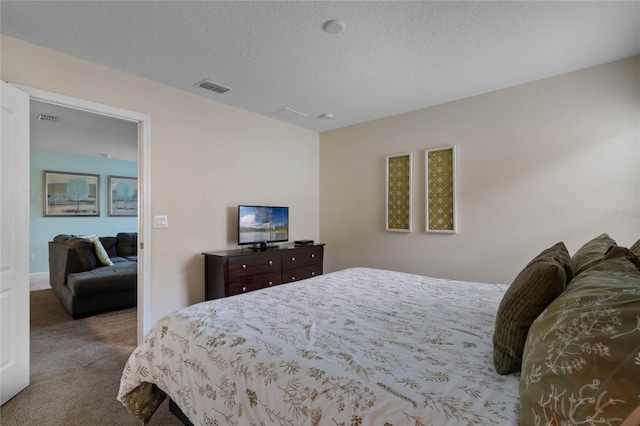 bedroom with a textured ceiling and carpet floors