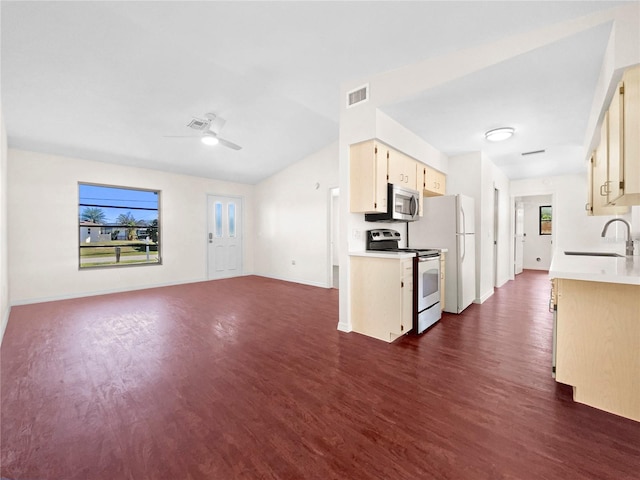 kitchen featuring white appliances, ceiling fan, dark wood-type flooring, and sink