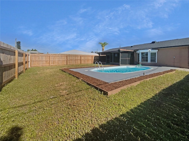 view of pool with a yard