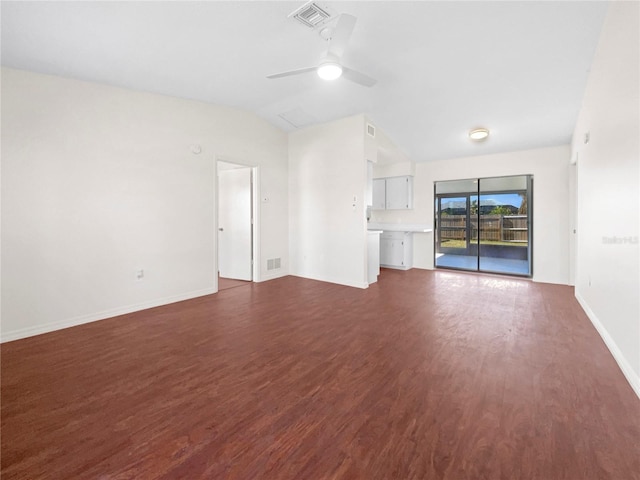 unfurnished living room featuring dark hardwood / wood-style floors, vaulted ceiling, and ceiling fan