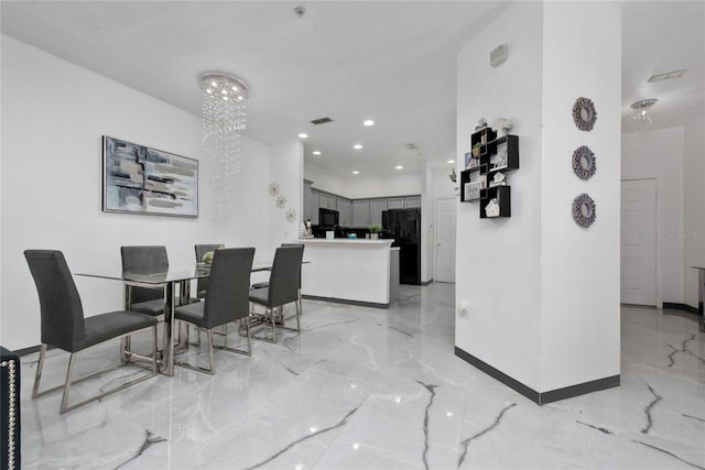 dining space featuring a notable chandelier