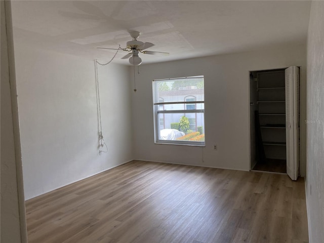 spare room with light hardwood / wood-style floors and ceiling fan