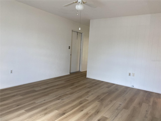 empty room featuring ceiling fan and wood-type flooring