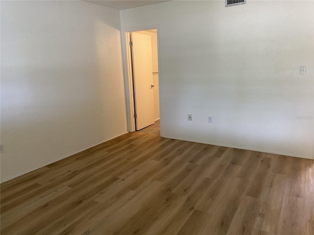 empty room featuring dark wood-type flooring