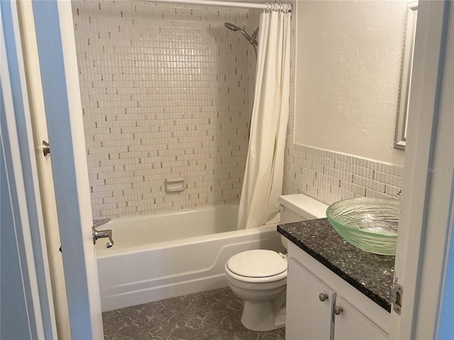 full bathroom featuring vanity, toilet, shower / bathtub combination with curtain, and tile walls