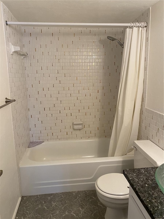 full bathroom with tile walls, vanity, shower / bath combo, and toilet