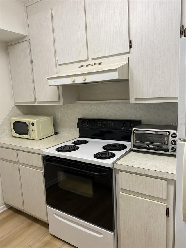 kitchen with light hardwood / wood-style flooring and white appliances