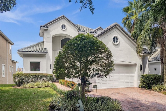 mediterranean / spanish home featuring a garage