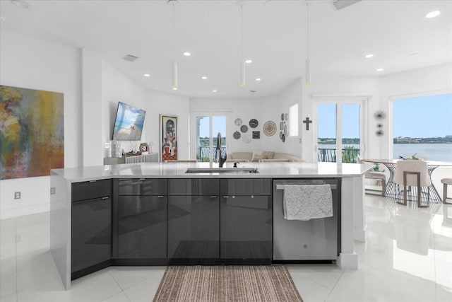 kitchen with sink, light tile patterned floors, and stainless steel dishwasher