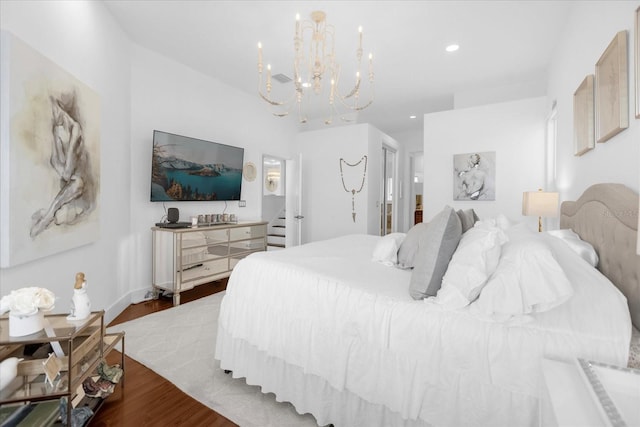 bedroom featuring hardwood / wood-style floors and a chandelier