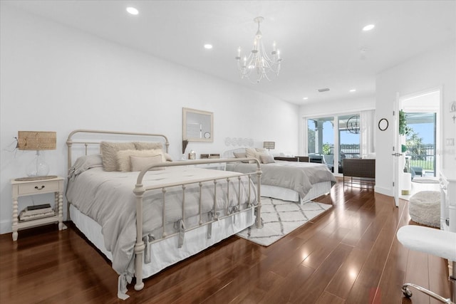 bedroom featuring access to exterior, dark hardwood / wood-style flooring, and an inviting chandelier