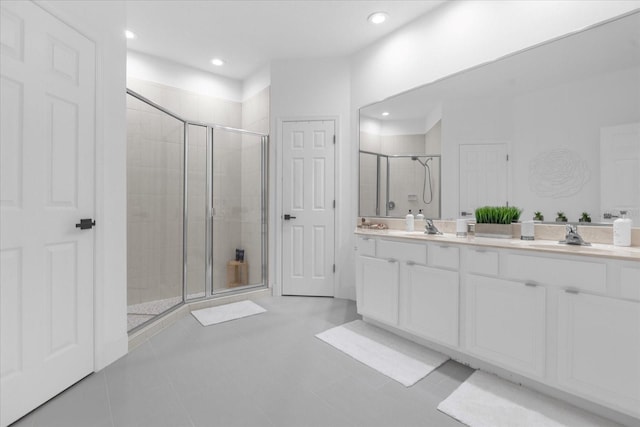 bathroom featuring tile patterned flooring, vanity, and a shower with shower door