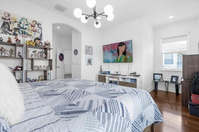 bedroom with an inviting chandelier and dark wood-type flooring