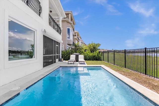 view of swimming pool featuring a sunroom