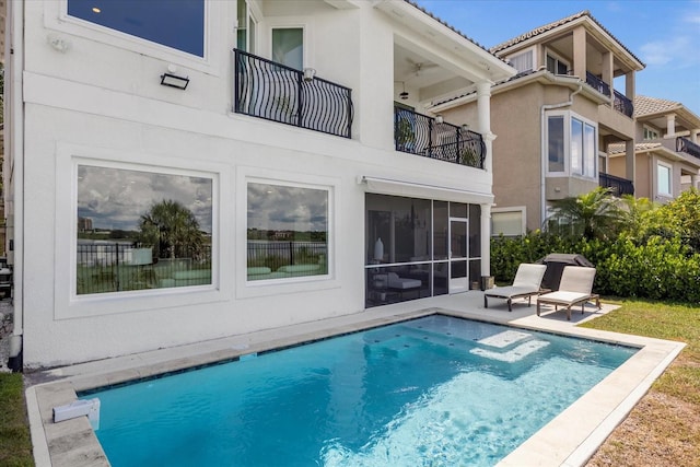 rear view of property with a patio area and a sunroom