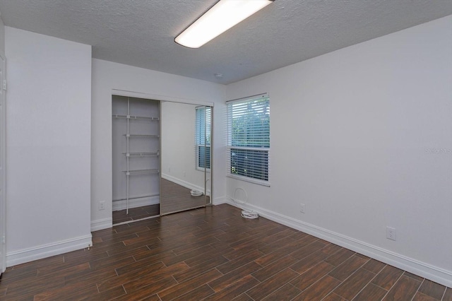 unfurnished bedroom with a closet and a textured ceiling