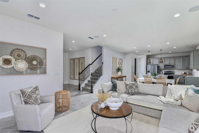 living room featuring light tile patterned flooring and sink