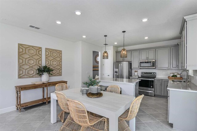 dining area with sink and light tile patterned floors