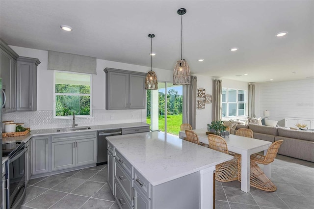 kitchen featuring sink, dishwasher, a center island, gray cabinets, and black range with electric stovetop