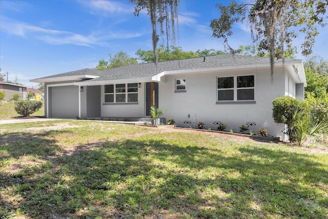 ranch-style house featuring a garage and a front lawn