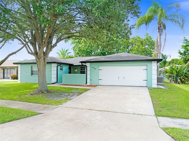 single story home featuring a garage and a front lawn