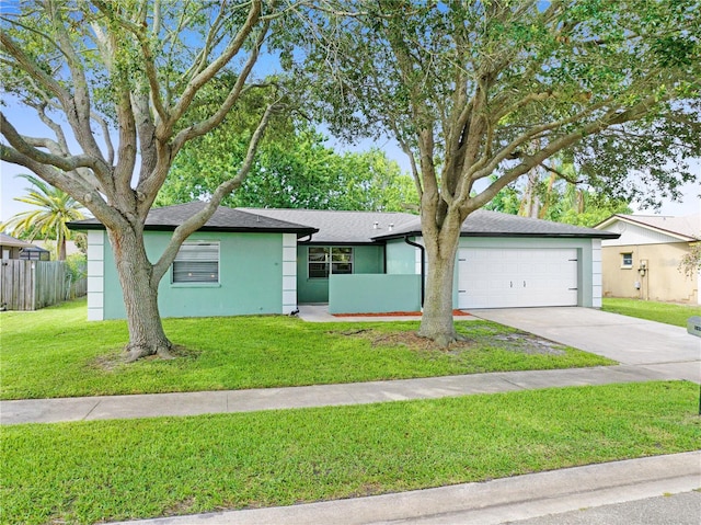 ranch-style home featuring a garage and a front lawn