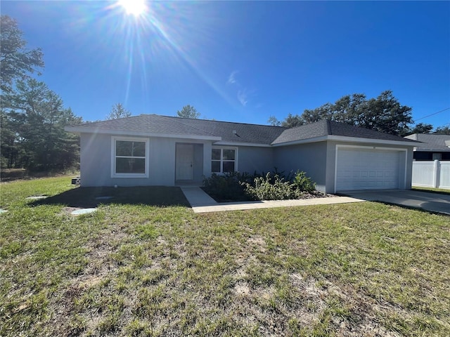 single story home featuring a garage and a front yard