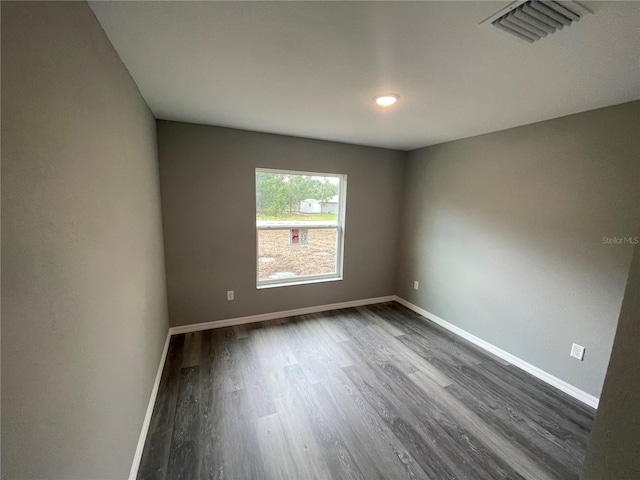 spare room featuring dark hardwood / wood-style floors