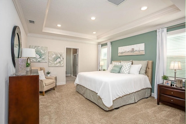 bedroom featuring ornamental molding, light colored carpet, a textured ceiling, and a tray ceiling