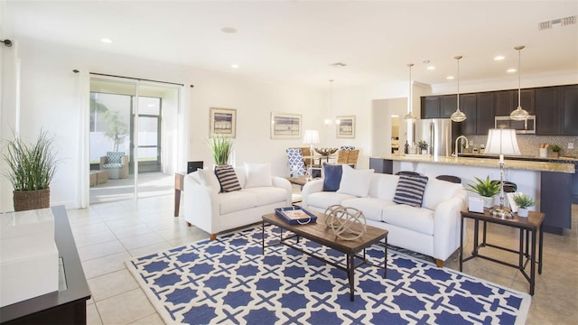 living room featuring sink and light tile patterned floors