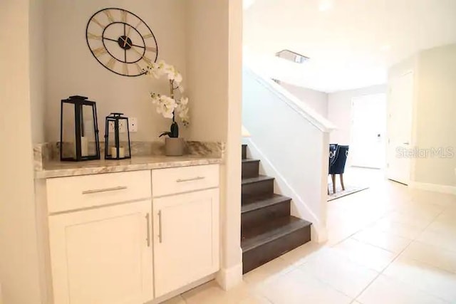 interior space featuring white cabinets and light tile patterned floors