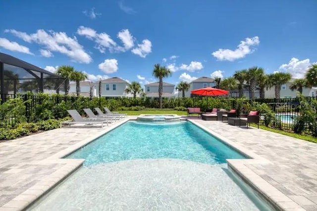 view of pool featuring a patio area and an in ground hot tub