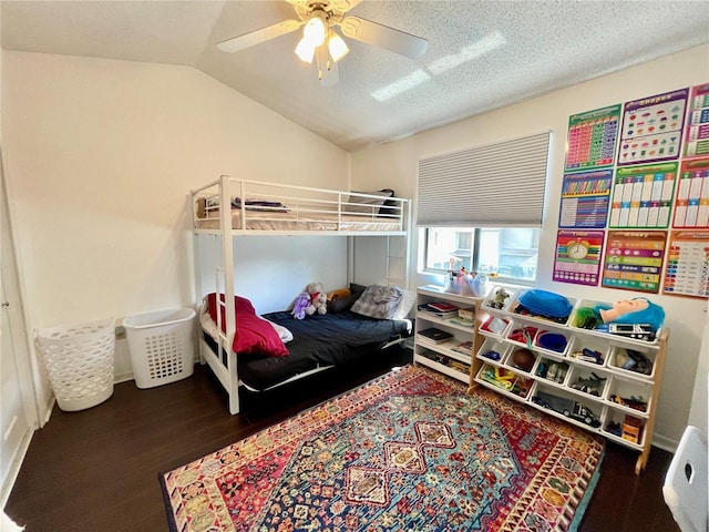 bedroom featuring a textured ceiling, vaulted ceiling, ceiling fan, and dark wood-type flooring