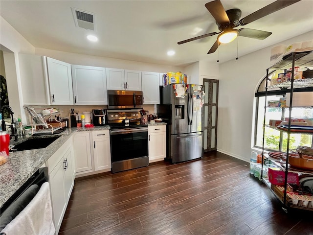 kitchen featuring white cabinets, light stone counters, sink, and appliances with stainless steel finishes