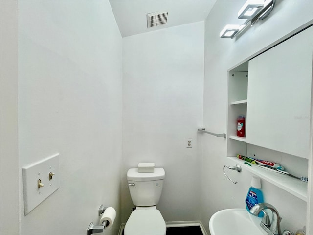 bathroom featuring toilet and sink