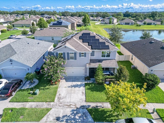 drone / aerial view featuring a residential view and a water view