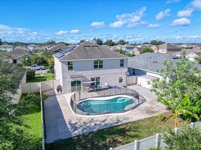 view of pool with a gate, a fenced in pool, a fenced backyard, a patio area, and a residential view